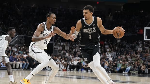 San Antonio Spurs forward Victor Wembanyama (1) drives to the basket while defended by Brooklyn Nets center Nicolas Claxton (33)